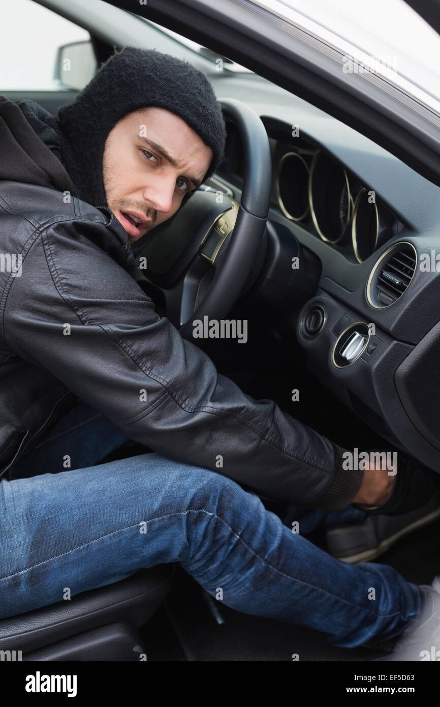 Thief breaking into a car Stock Photo Alamy