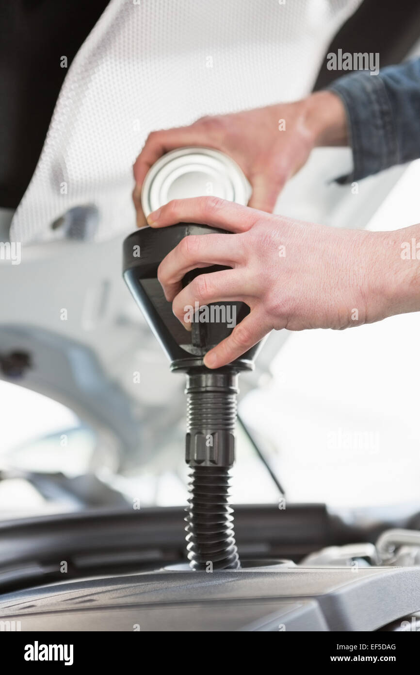 Man pouring oil into engine Stock Photo Alamy