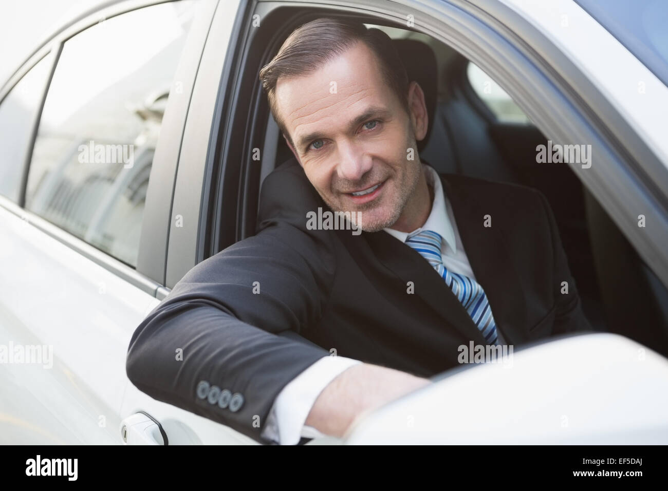Handsome businessman smiling at camera Stock Photo - Alamy