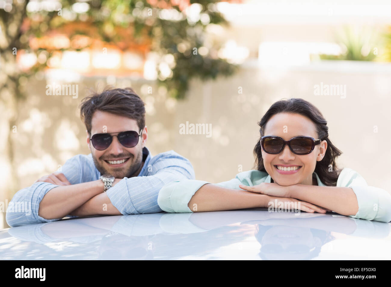Young couple smiling at the camera Stock Photo - Alamy