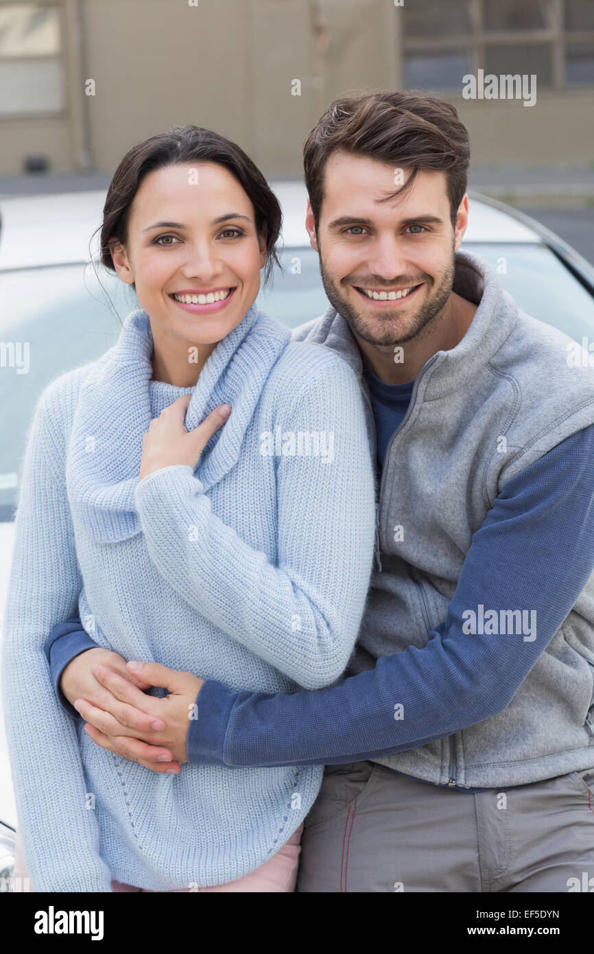 Young couple smiling at the camera Stock Photo - Alamy