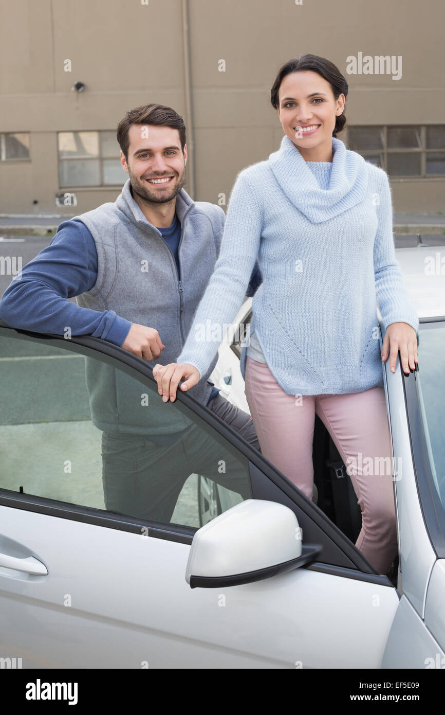 Young couple smiling at camera Stock Photo - Alamy