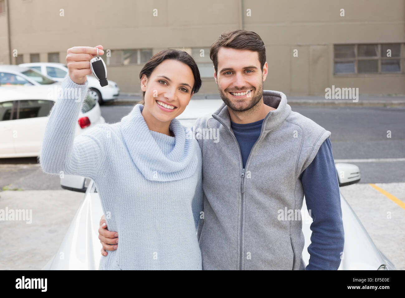 Young couple smiling holding new key Stock Photo - Alamy
