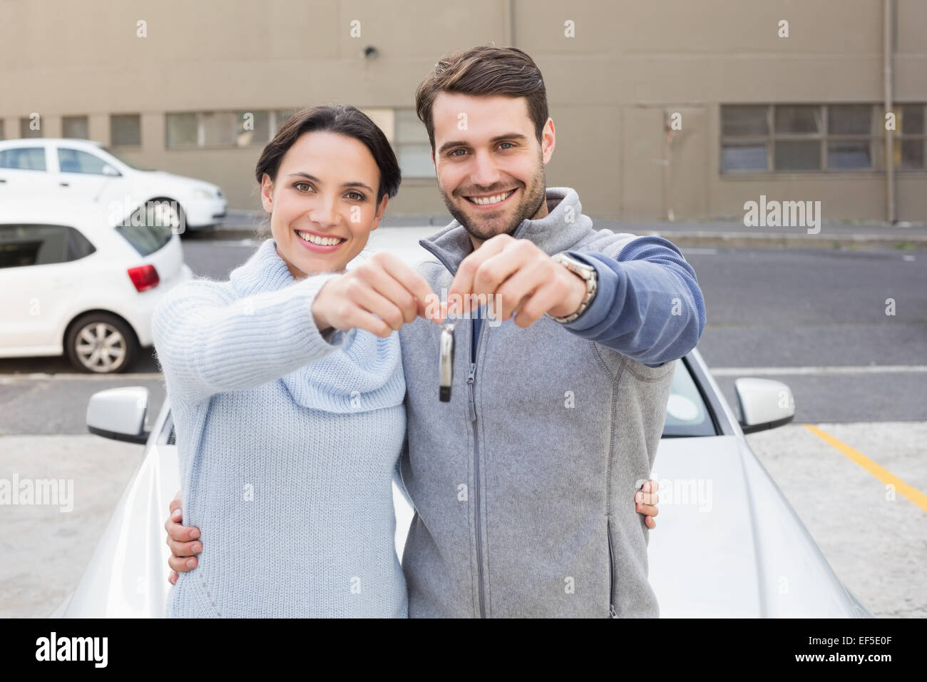 Young couple smiling holding new key Stock Photo - Alamy
