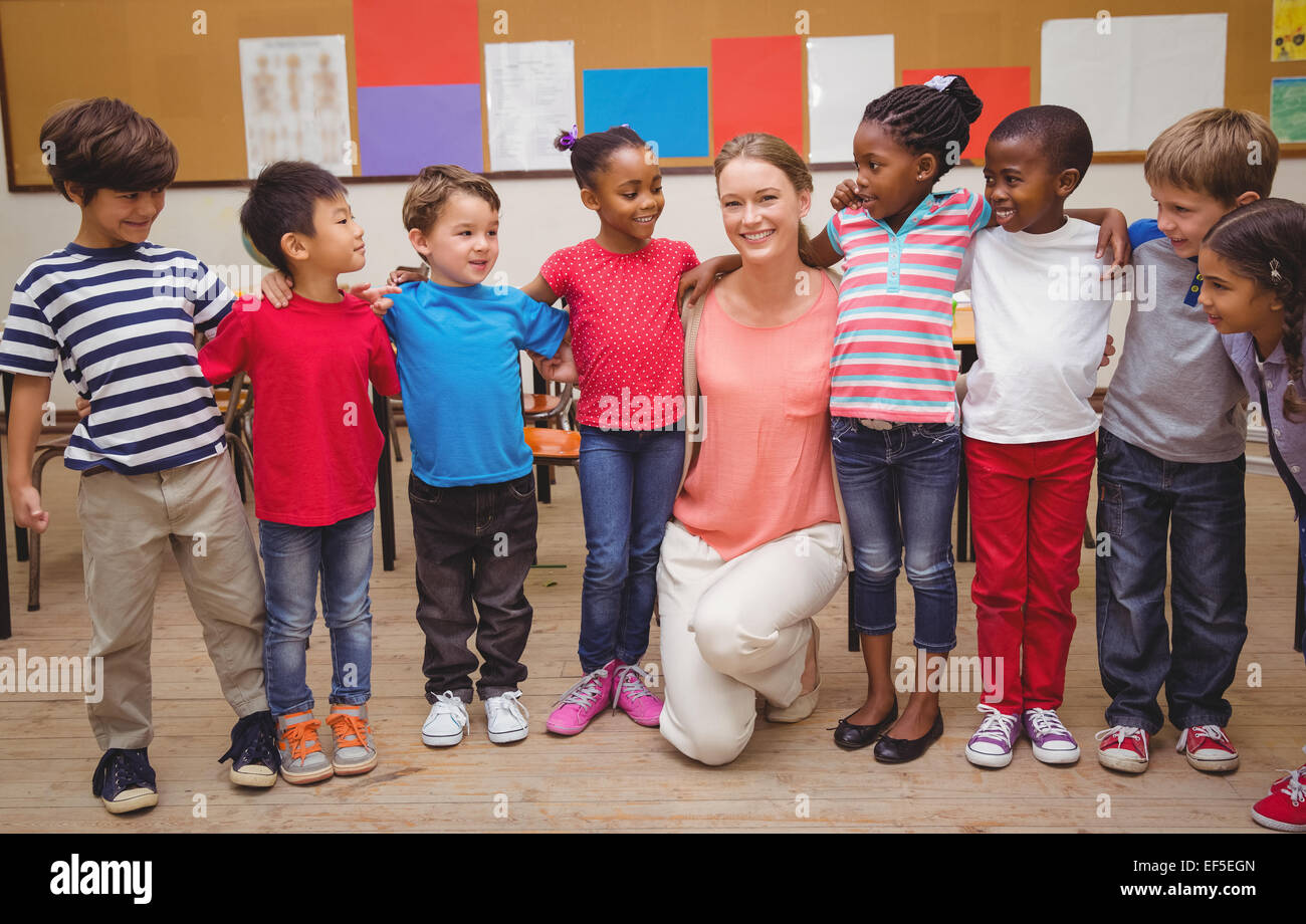 Teacher and pupils smiling at camera in classroom Stock Photo Alamy