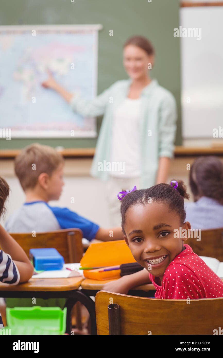 Cute pupil smiling at camera at his desk in classroom Stock Photo - Alamy