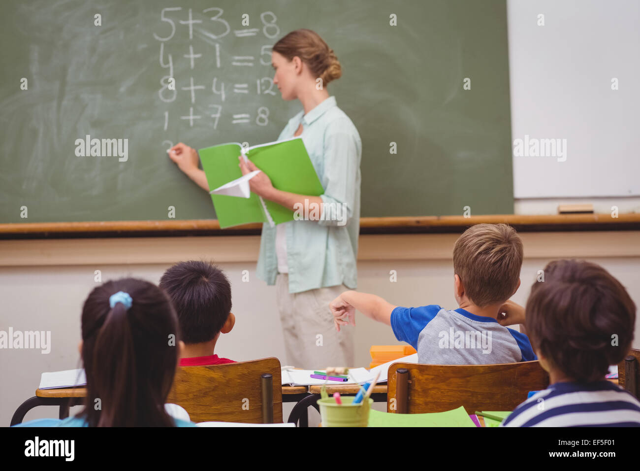 Naughty pupil throwing paper airplane in class Stock Photo