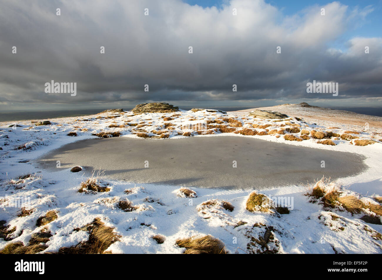 Frozen pond on High Willhays with Yes Tor in the distance Dartmoor National Park Devon Uk Stock Photo