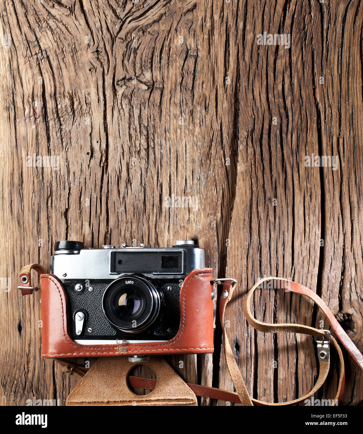Old rangefinder camera on the old wooden table. Stock Photo