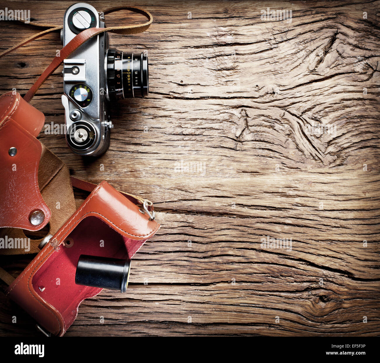 Old rangefinder camera on the old wooden table. Stock Photo
