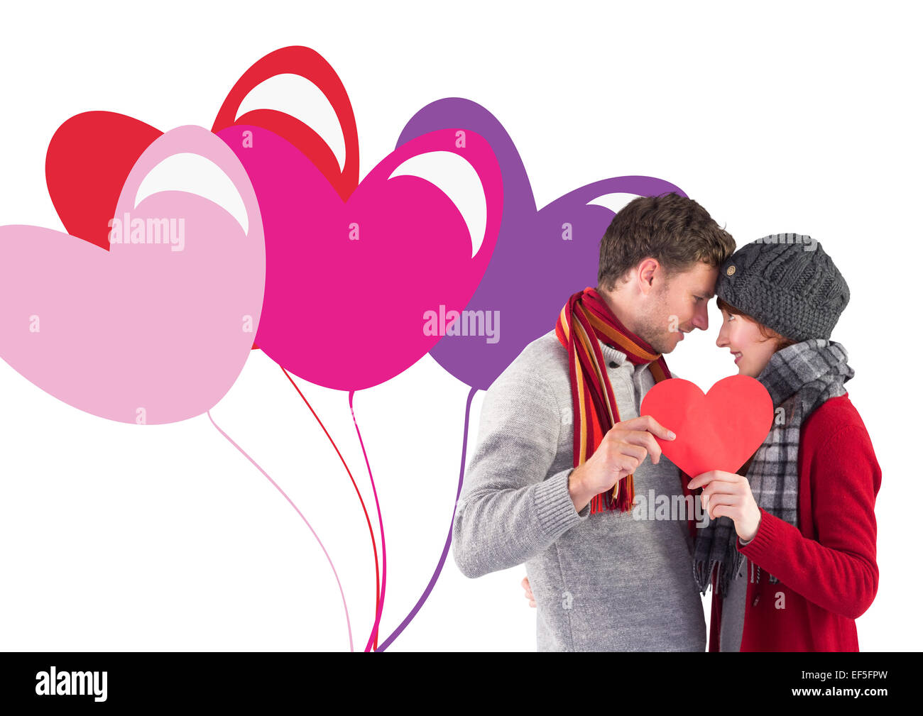 Composite image of couple holding a red heart Stock Photo - Alamy