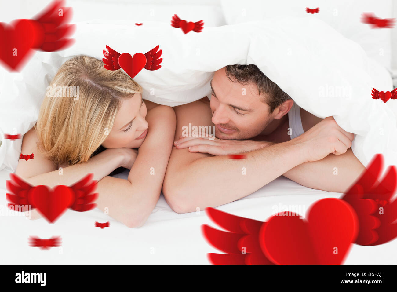 Composite image of lovely couple in their bed Stock Photo