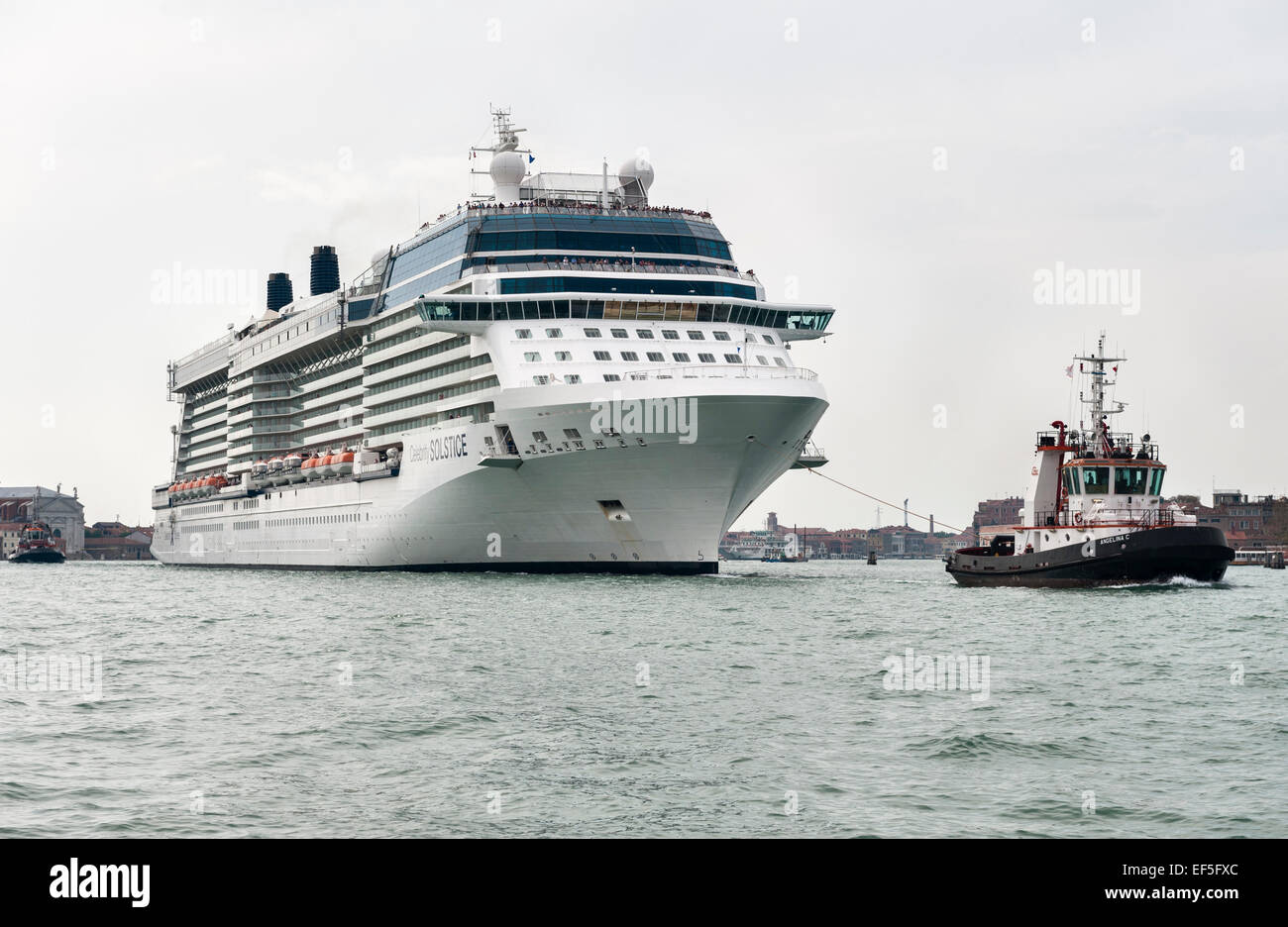 The Cruise Ship Celebrity Solstice Is Towed Into The Port Of Venice Italy Stock Photo Alamy