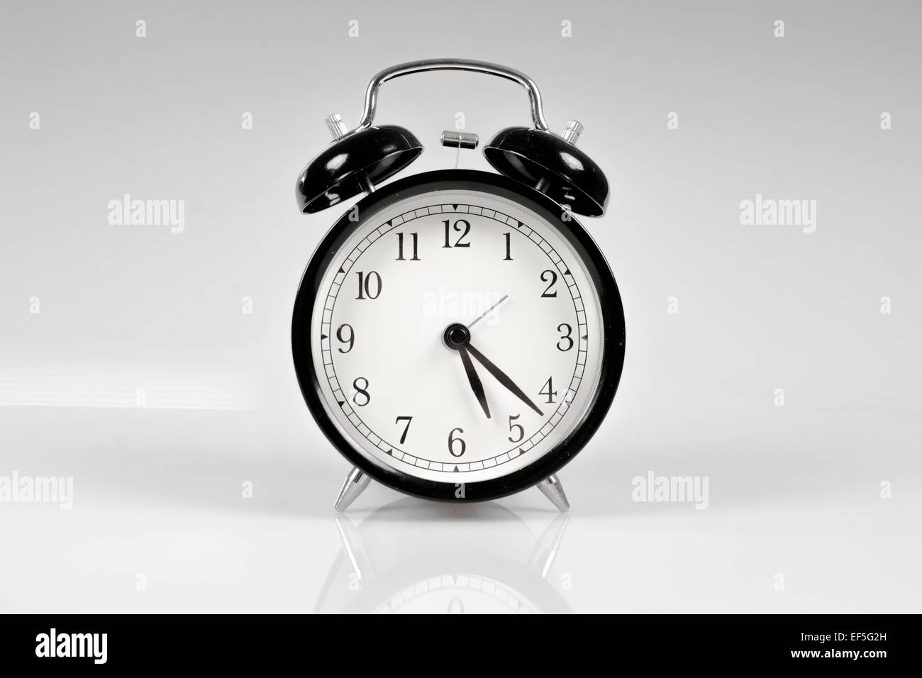 Classic alarm clock on a table Stock Photo Alamy