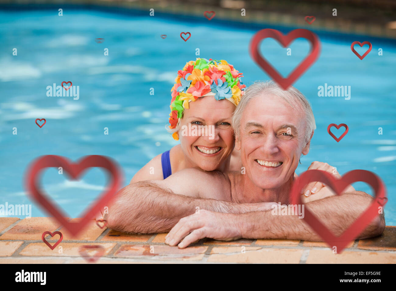 Composite image of happy mature couple in the swimming pool Stock Photo