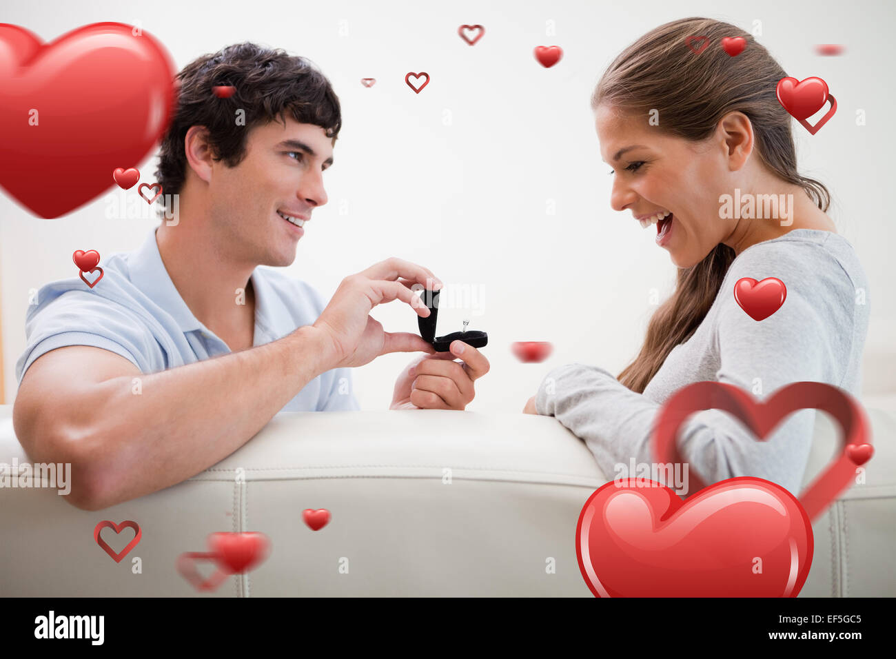 Composite image of man making a proposal to his girlfriend Stock Photo