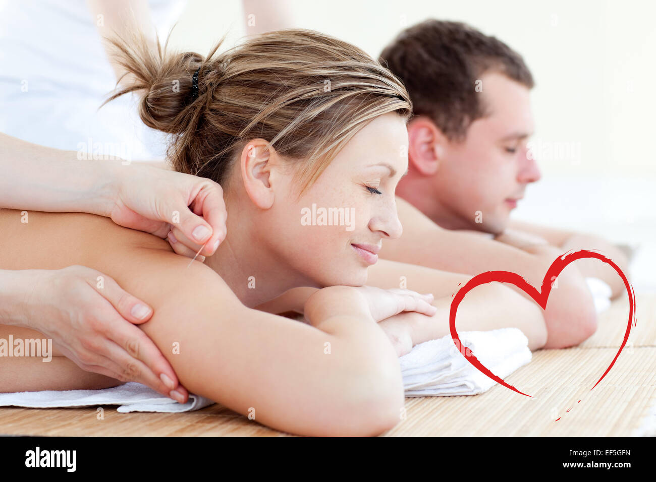 Composite image of loving couple having an acupunctre therapy Stock Photo