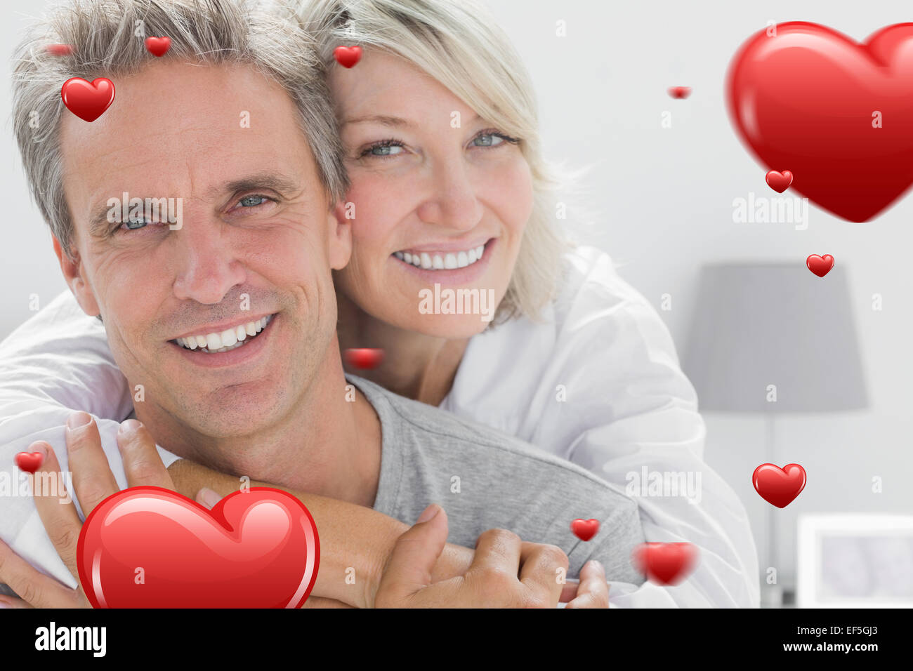 Composite image of affectionate couple smiling Stock Photo