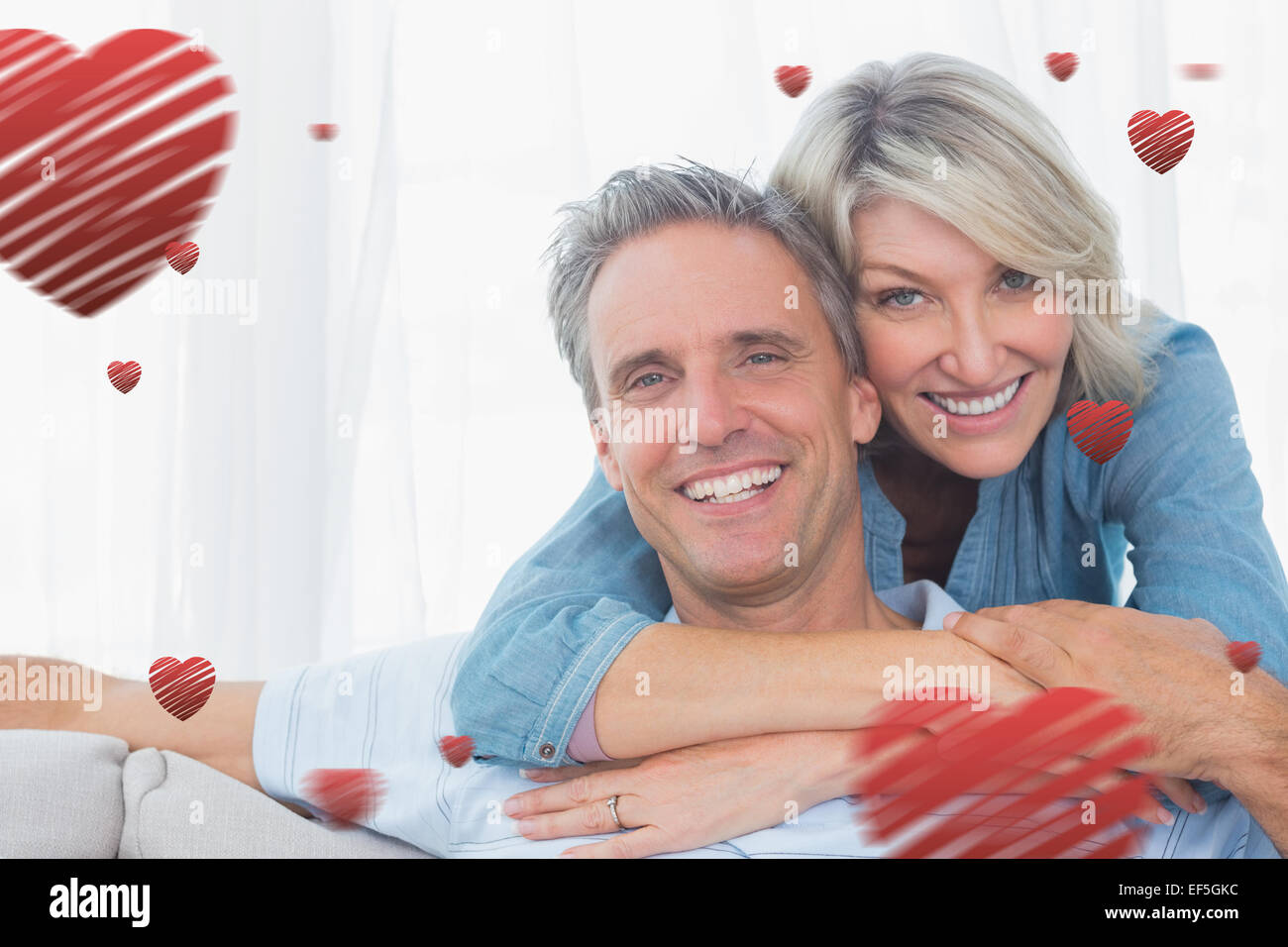 Composite image of couple smiling at the camera Stock Photo - Alamy