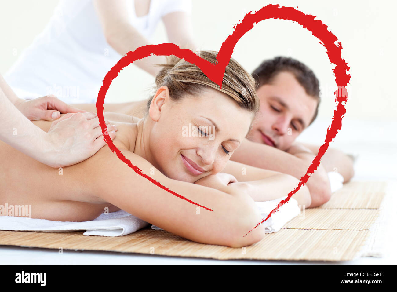 Composite image of affectionate couple having a back massage with closed eyes Stock Photo