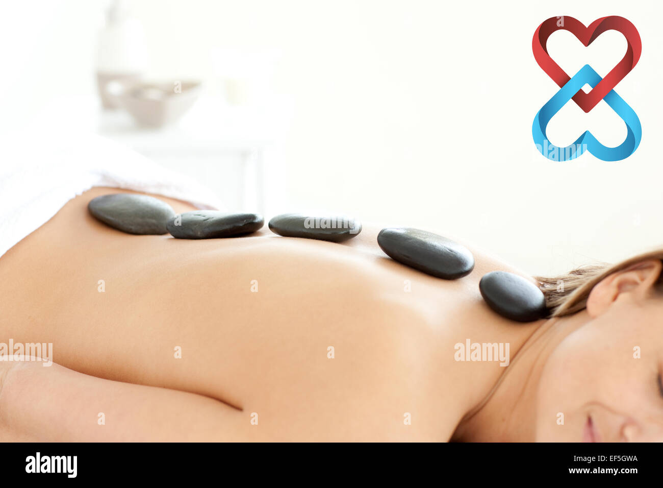 Composite image of attractive woman receiving a spa treatment Stock Photo