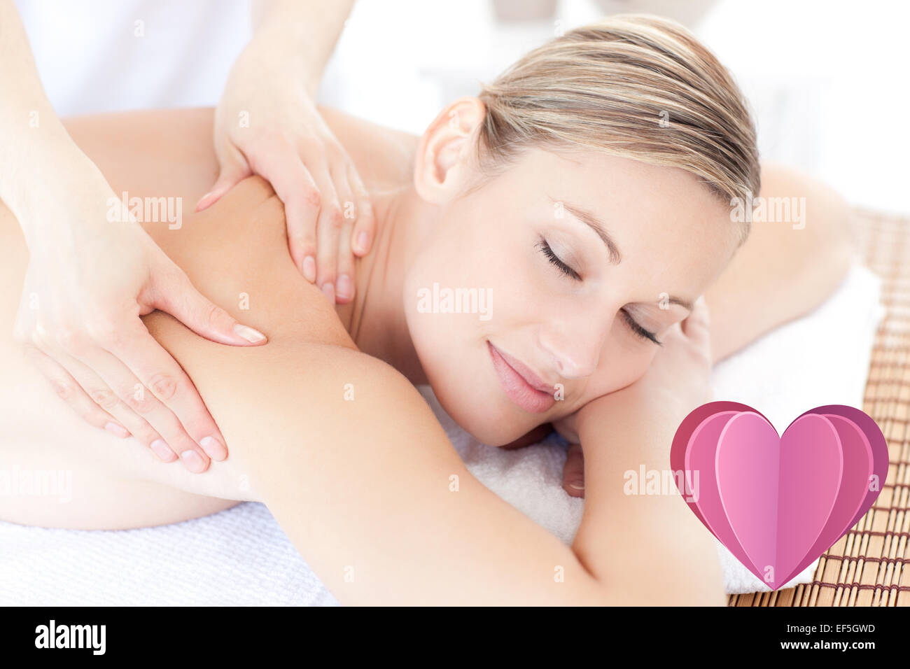 Composite image of beautiful woman receiving a back massage Stock Photo