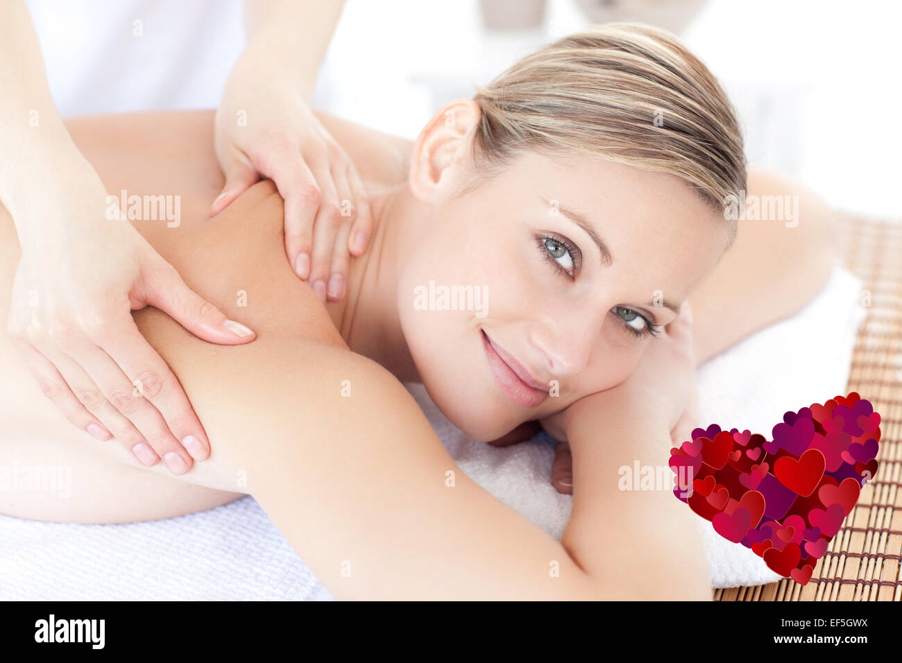 Composite image of smiling woman receiving a back massage Stock Photo