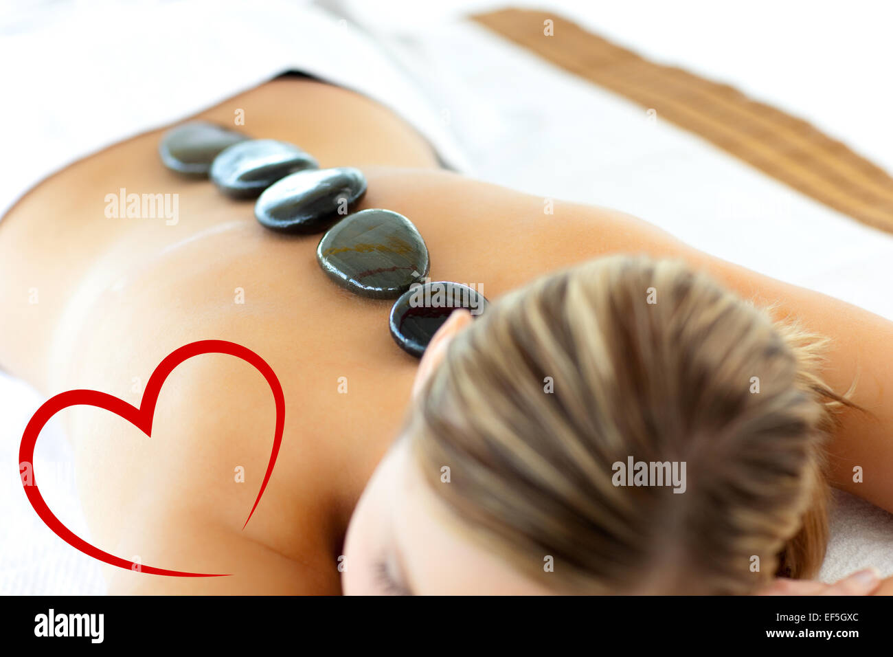 Composite image of confident woman having a massage Stock Photo