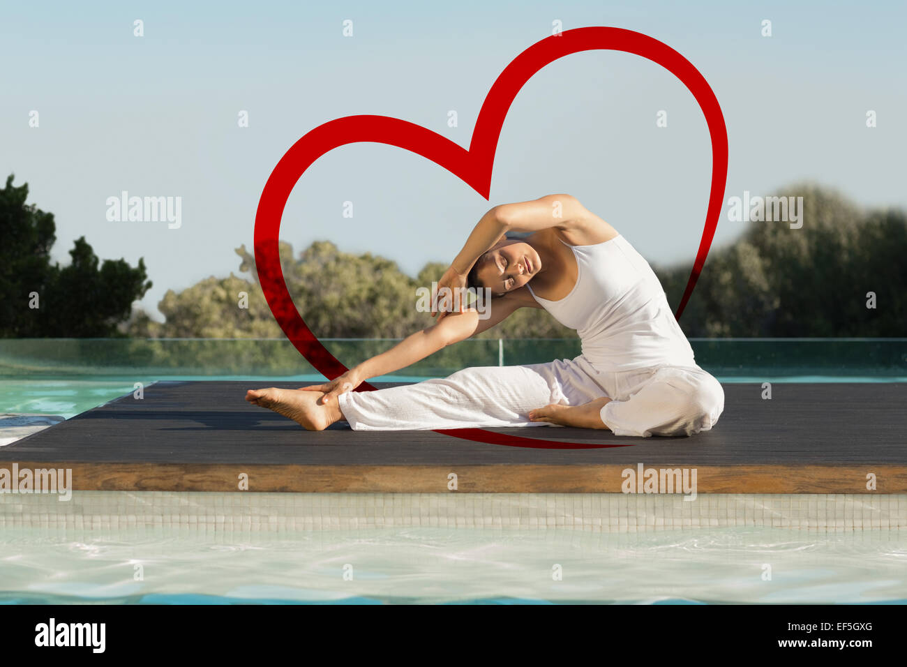 Composite image of peaceful brunette in janu sirsasana yoga pose poolside Stock Photo