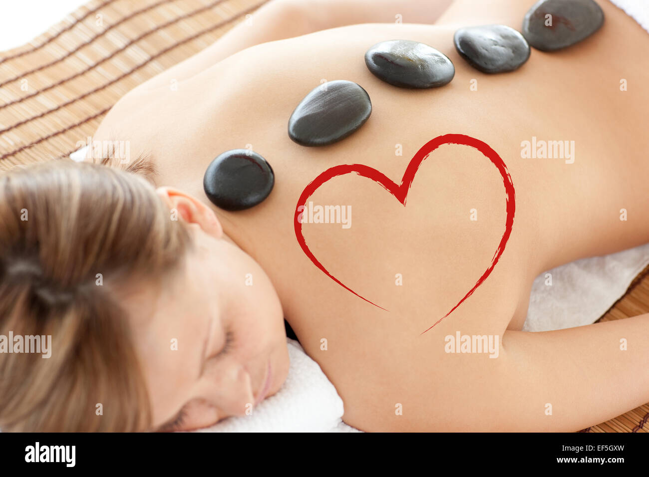 Composite image of bright woman lying on a massage table Stock Photo