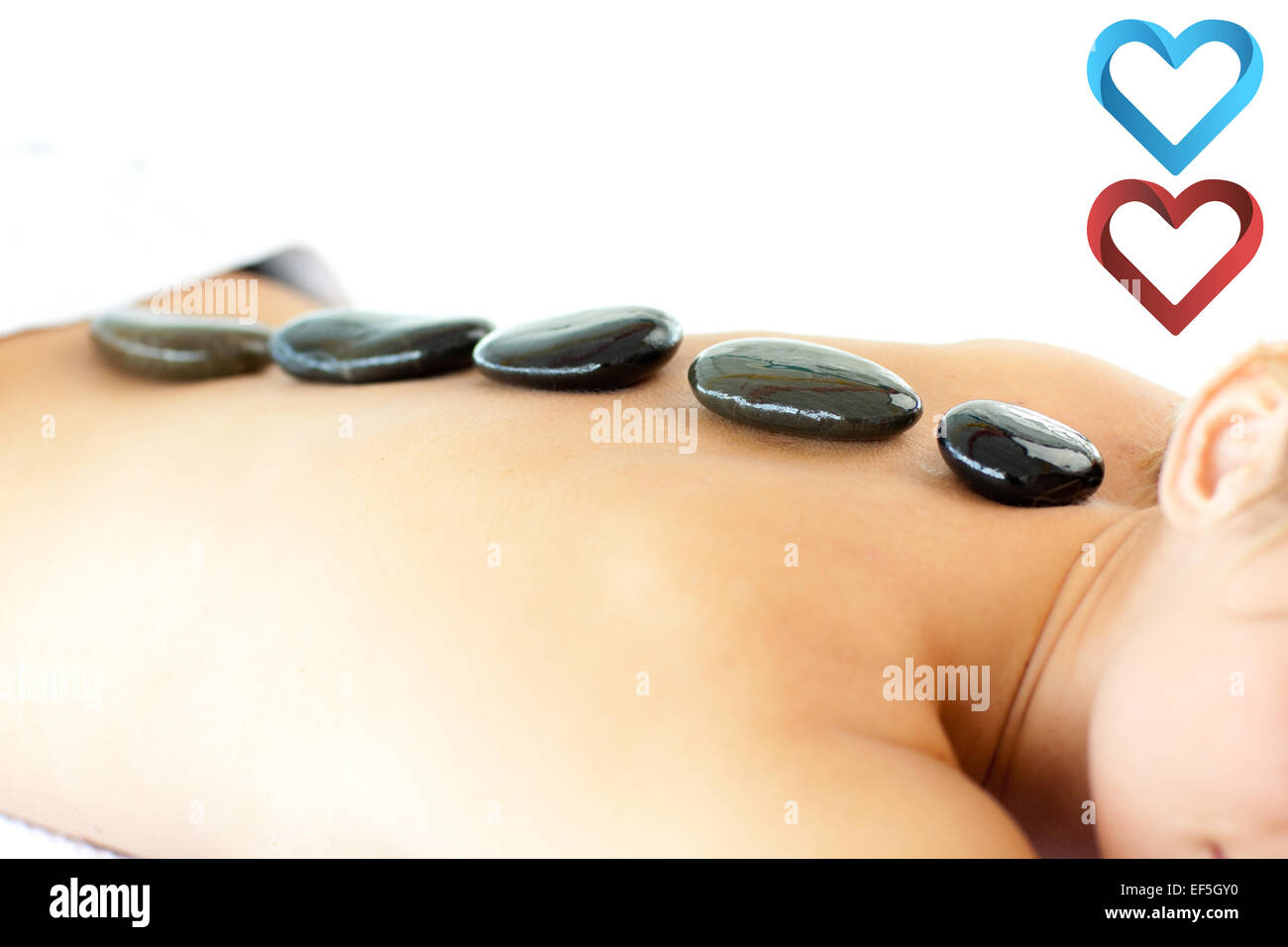 Composite image of portrait of a positive woman having a massage Stock Photo