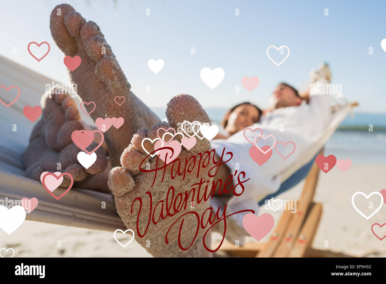 Composite image of close up of sandy feet of couple in a hammock Stock Photo
