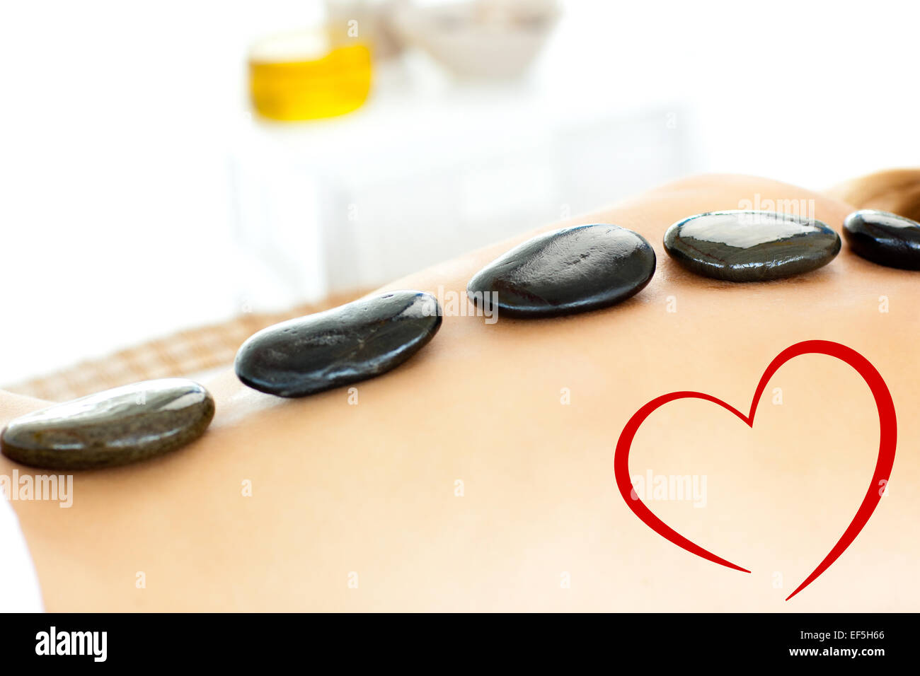 Composite image of close up of a beautiful woman having a massage Stock Photo