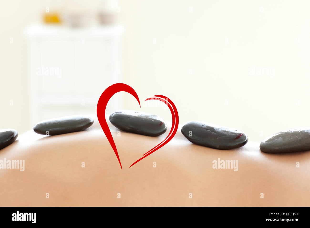 Composite image of woman lying on a massage table Stock Photo