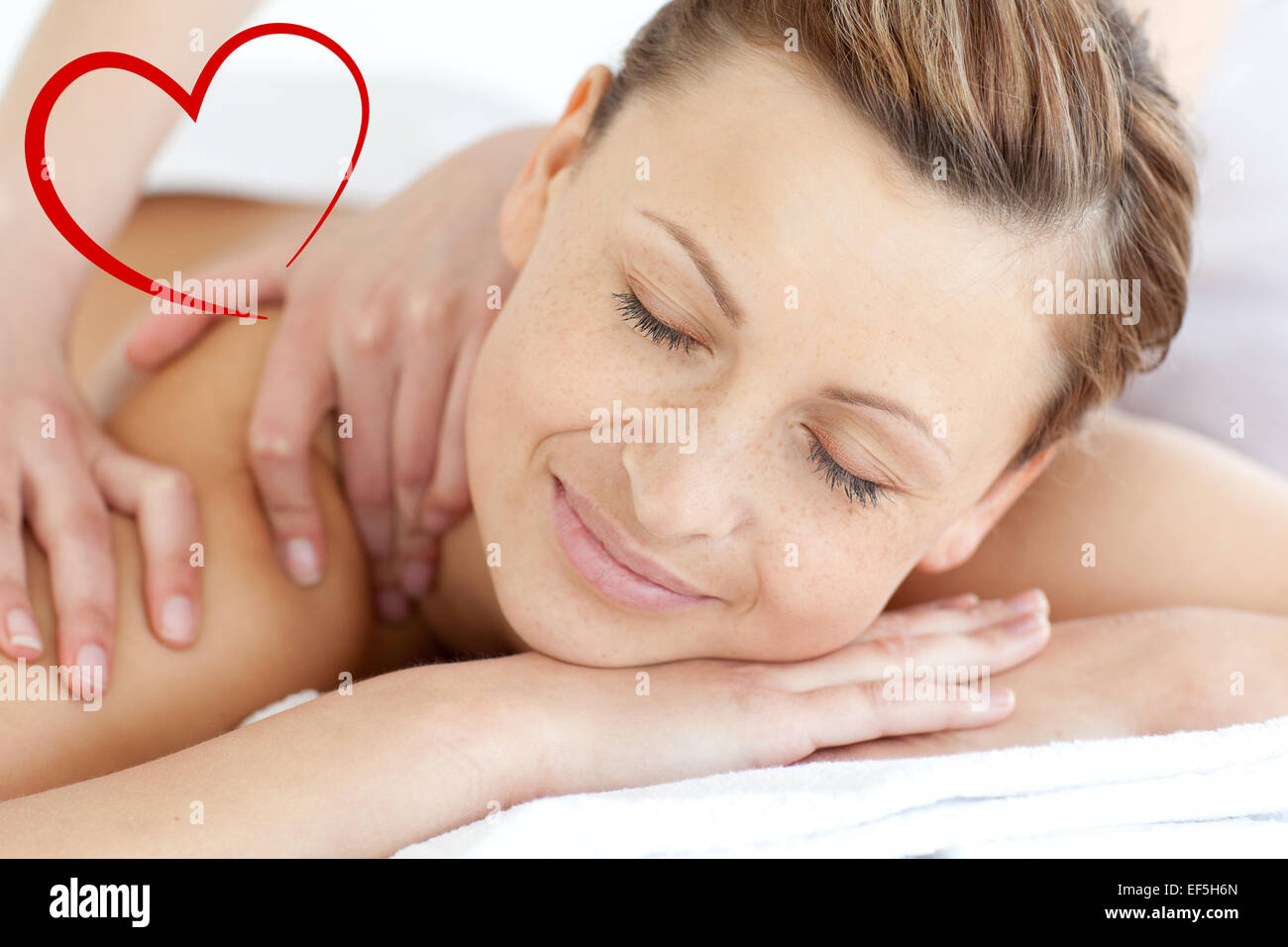 Composite image of charming woman enjoying a back massage Stock Photo