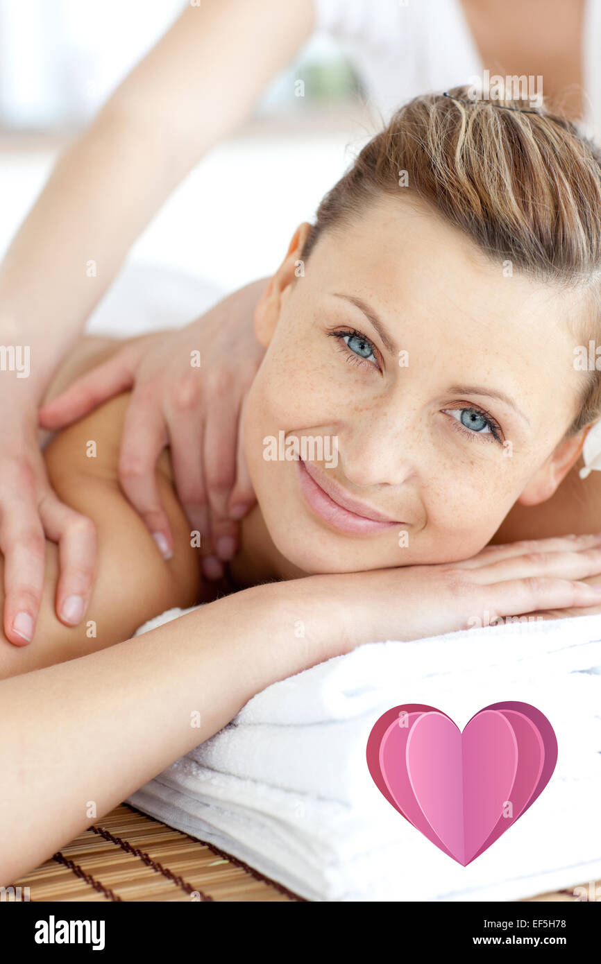 Composite image of cheerful woman enjoying a back massage Stock Photo