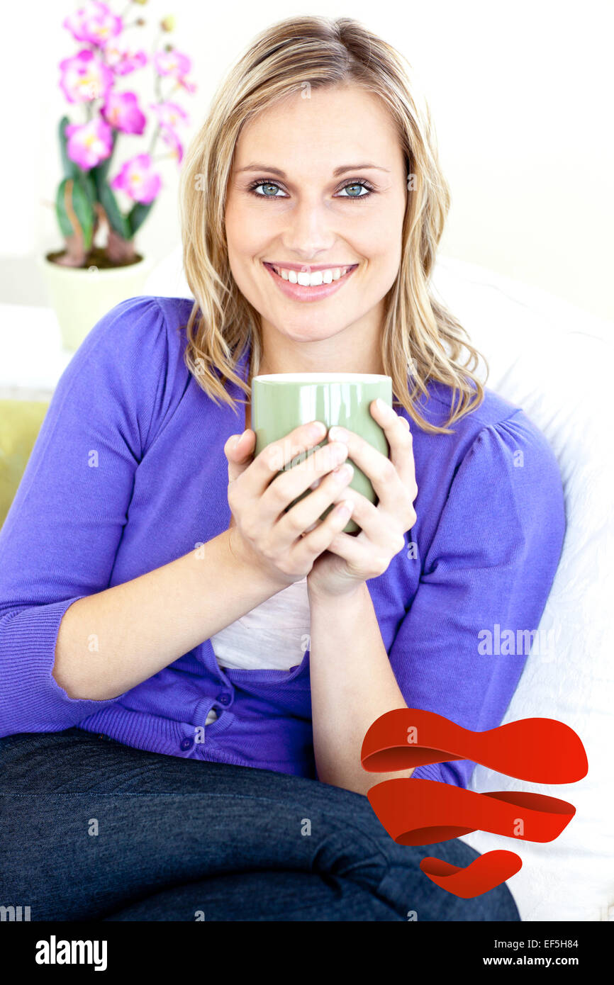 Composite image of blond woman enjoying her coffee sitting on the sofa in the livingroom Stock Photo