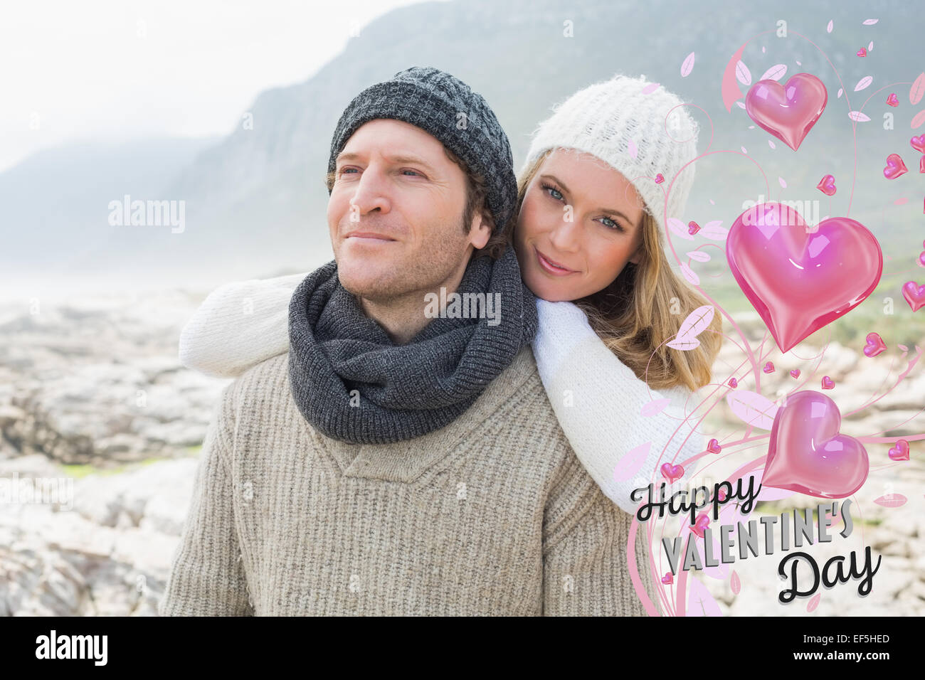 Composite image of romantic young couple together on a rocky landscape Stock Photo