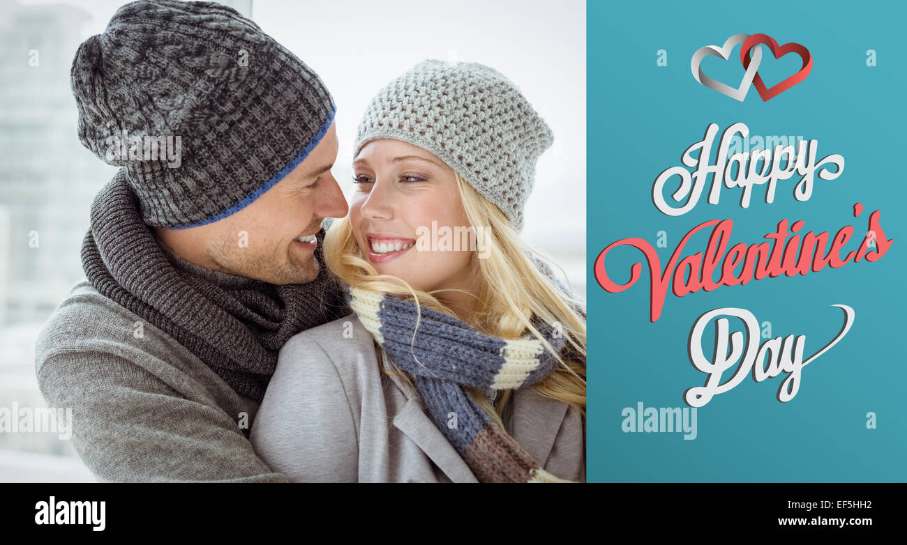 Composite image of cute couple in warm clothing smiling at each other ...