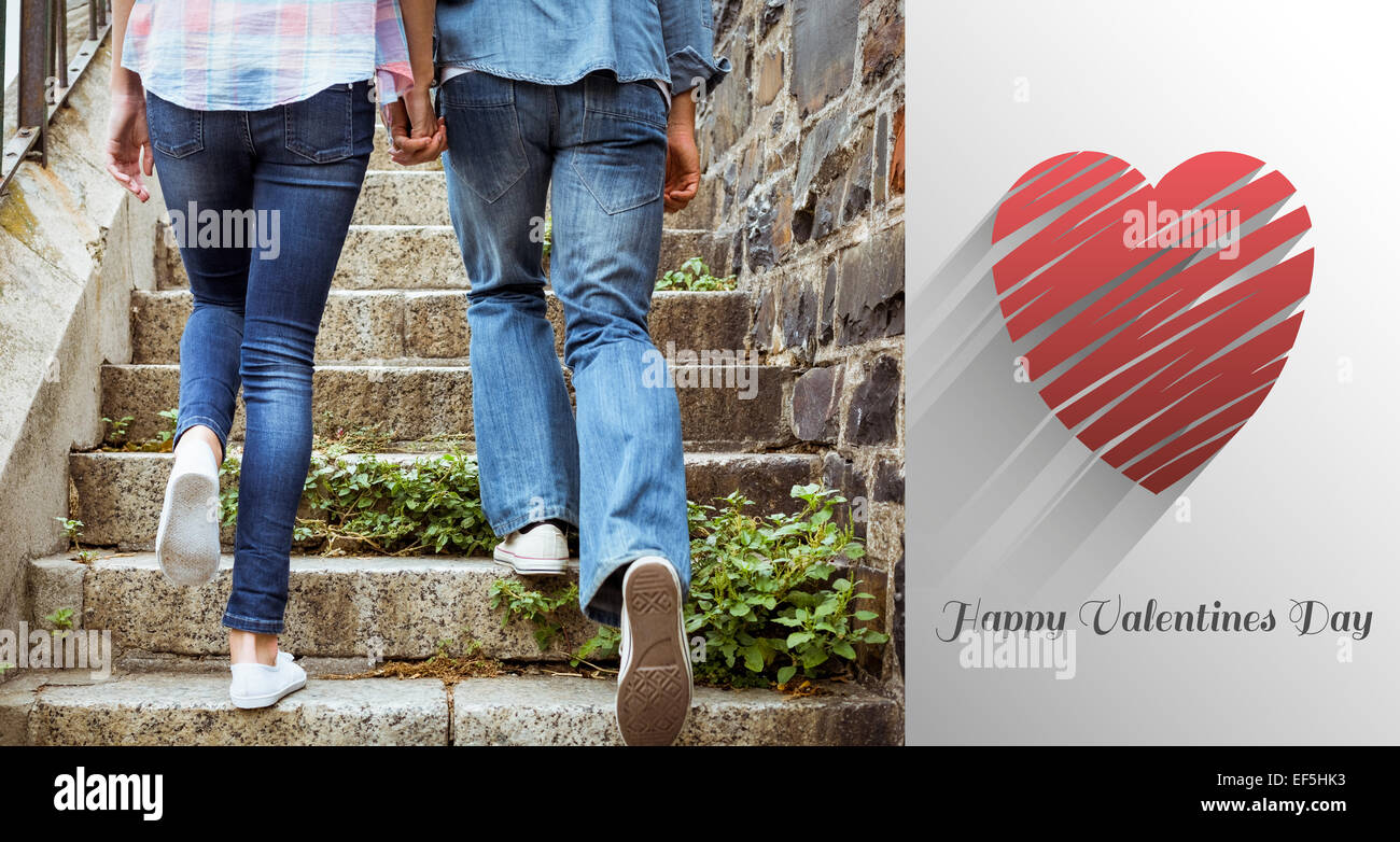 Composite image of hip young couple walking up steps Stock Photo