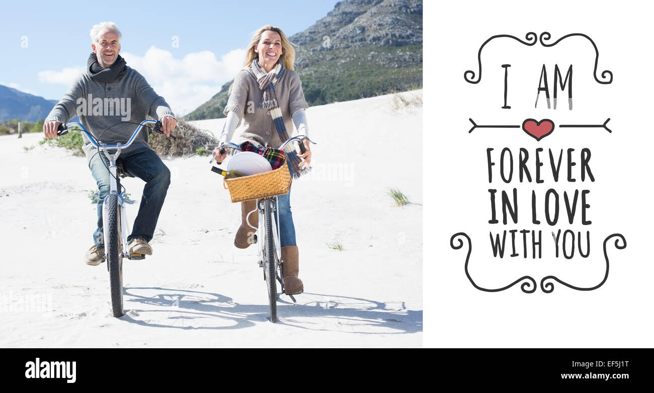 Composite image of carefree couple going for a bike ride and picnic on the beach Stock Photo