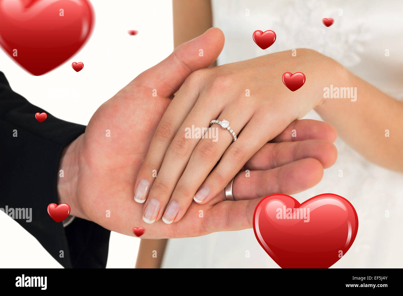 Composite image of cropped image of newly wed couple holding hands Stock Photo