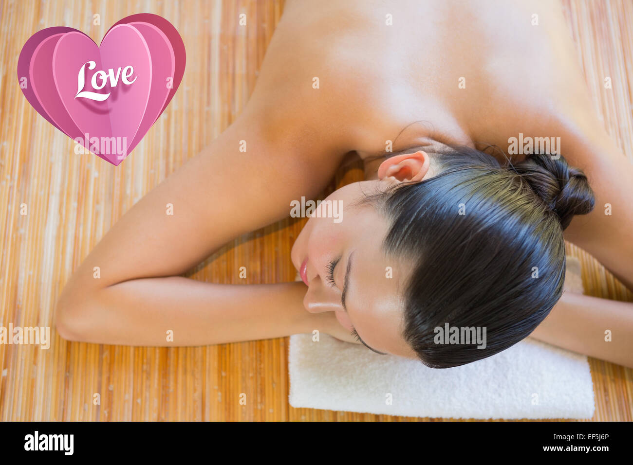Composite image of content brunette relaxing on massage table Stock Photo