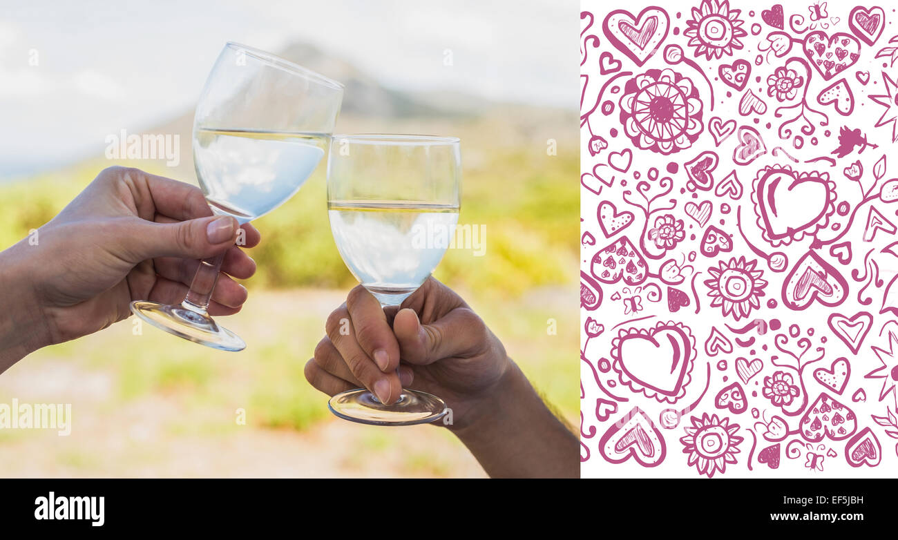 Composite image of couple clinking wine glasses outside Stock Photo
