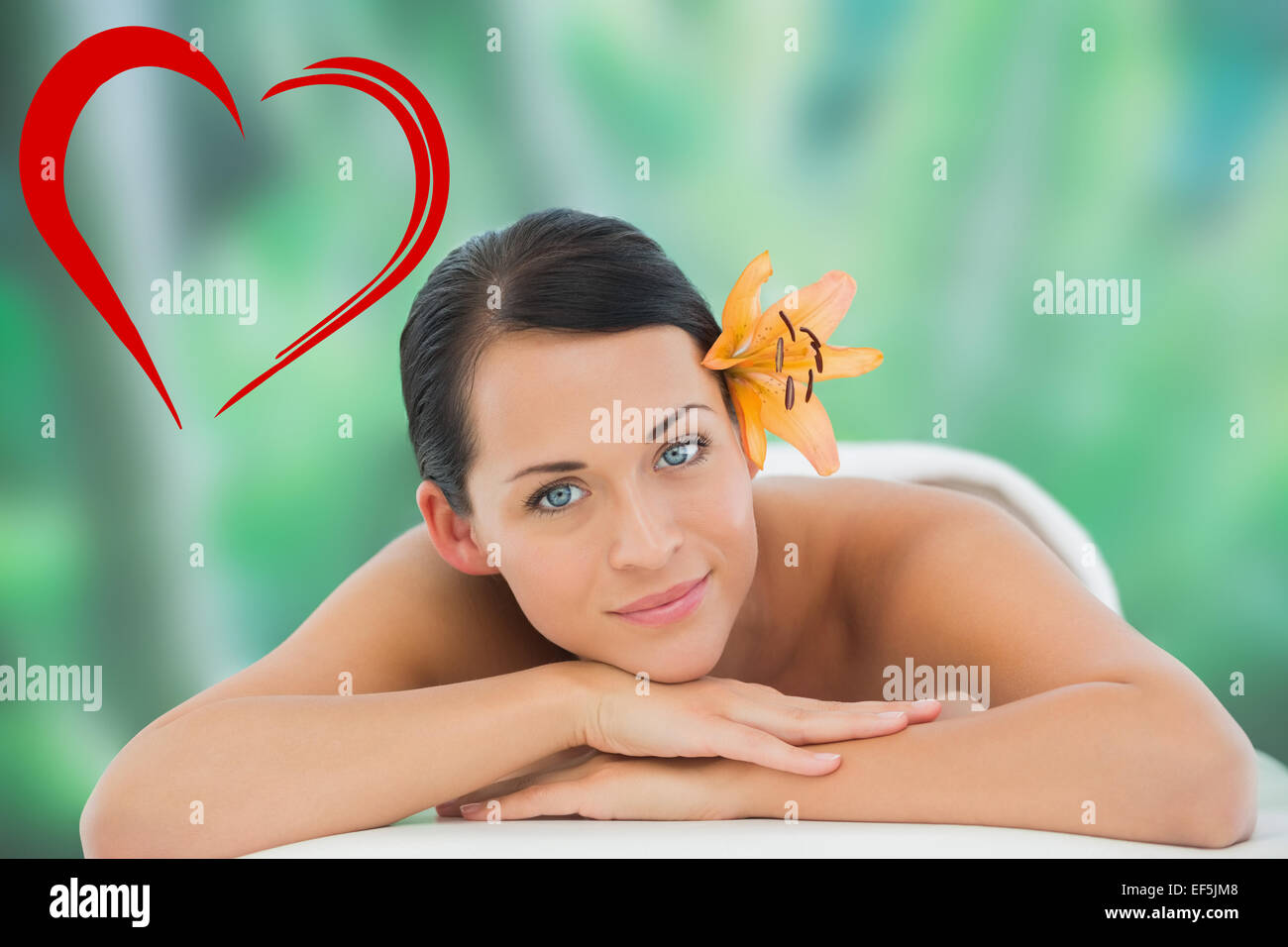 Composite image of beautiful brunette relaxing on massage table smiling at camera Stock Photo