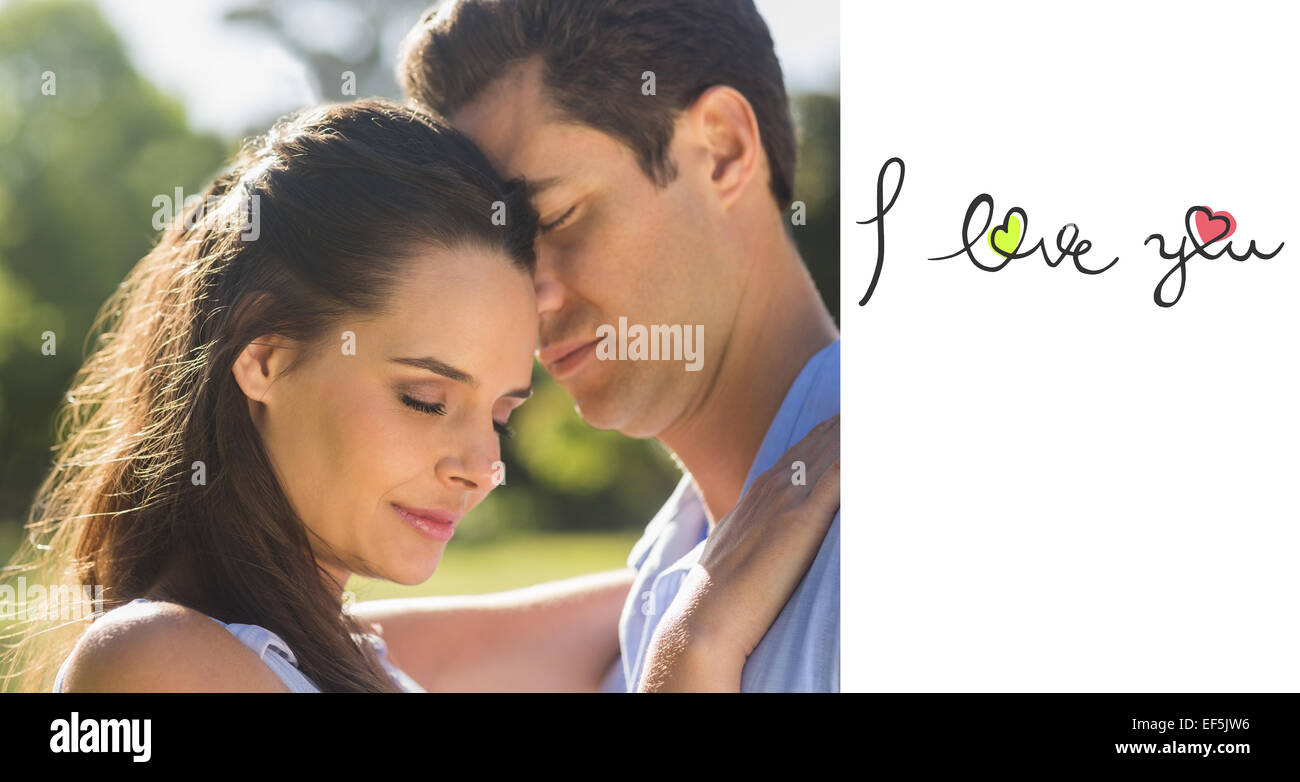 Composite image of close-up of loving couple embracing in park Stock Photo
