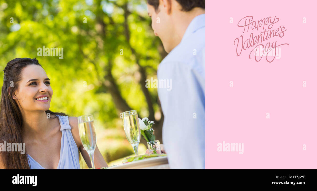 Composite image of couple with champagne flutes sitting at an outdoor cafÃ© Stock Photo