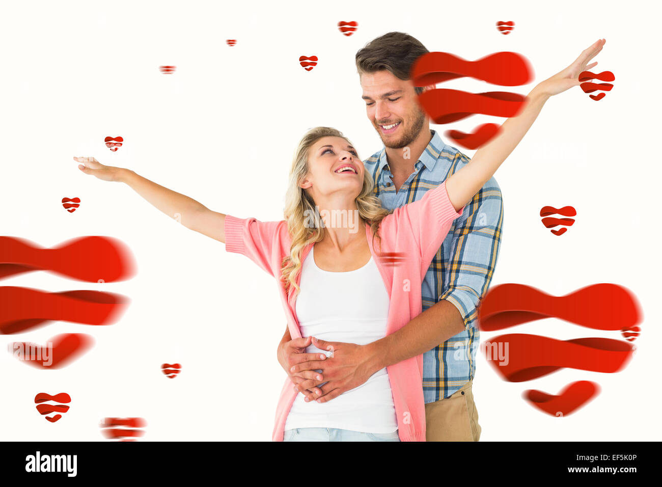 Composite image of attractive young couple smiling and embracing Stock ...