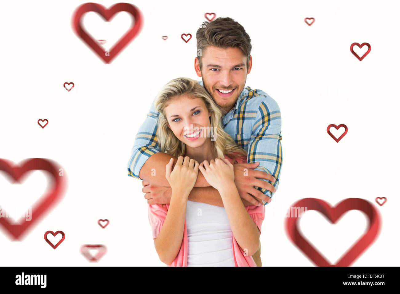 Composite image of attractive young couple smiling at camera Stock ...