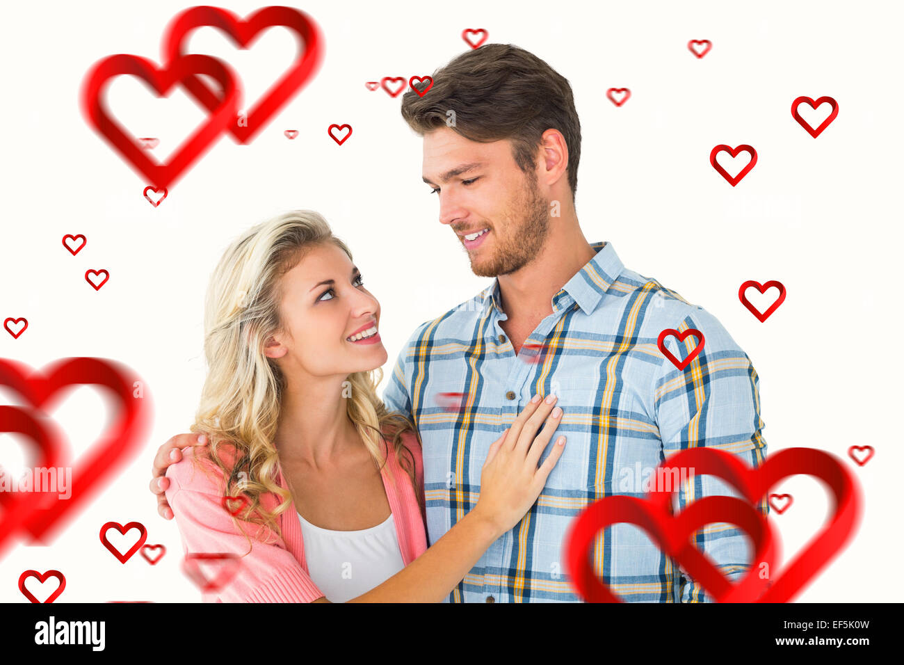 Composite image of attractive young couple smiling at each other Stock ...